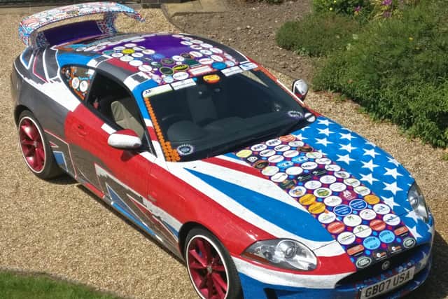 Stuart's current sticker car - 5-litre V8, 385 BHP, 155 mph limited.
With public stickers in red, white and blue making flags on each side of the car and company stickers down the centre