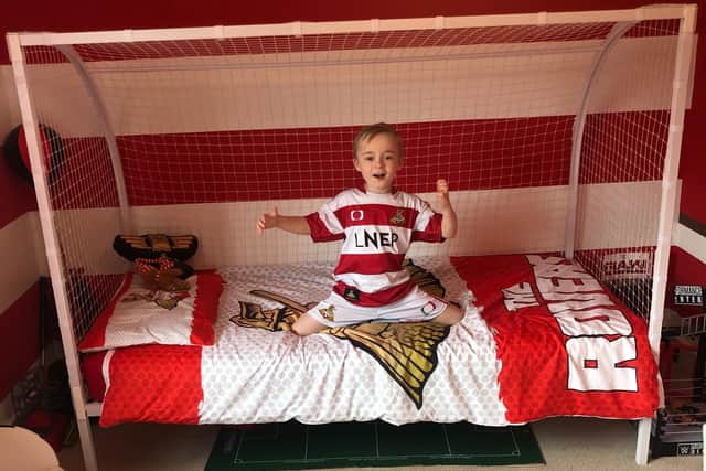 Oliver Laws in his Doncaster Rovers themed room, created after plans to mark his birthday as a mascot at doncaster Rovers collapsed