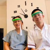 Nottinghamshire Freemason Ken Chui, a hospital radiographer, and his wife Gladys who is a carer, with two of the face masks