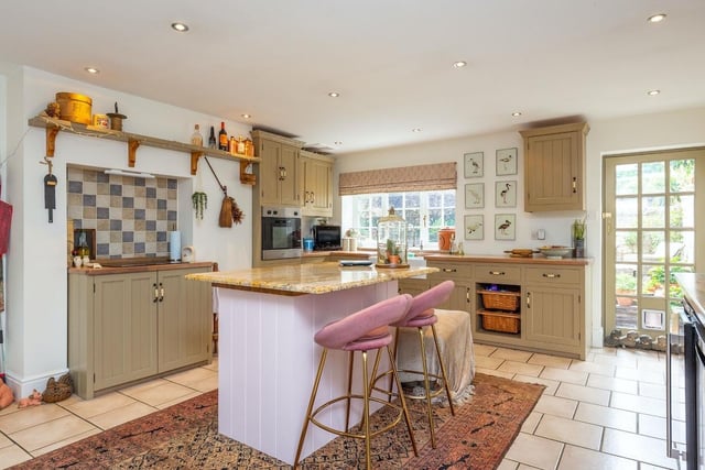 Let's begin our tour of The Old Coach House in the bright and well-appointed kitchen, which boasts modern appliances and ample storage space.
