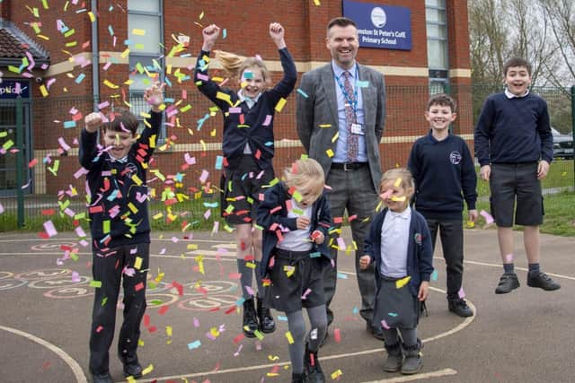 Head teacher Chris Edwards celebrates the school's Ofsted verdict with pupils.