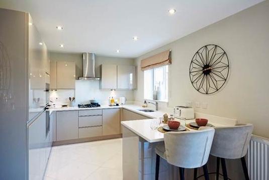 We begin our guided tour in the contemporary kitchen. Jayne Swift, sales and marketing director for Jones Homes, says: "The soft, light grey door fronts are simple and sleek, while the high-gloss finish reflects light around the room,as do the light quartz worktops."