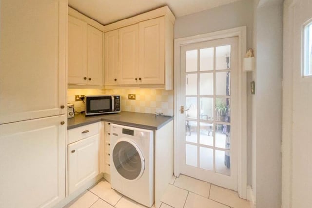 There is space and supply for a washing machine within the kitchen, which also contains a walk-in pantry and two storage cupboards.
