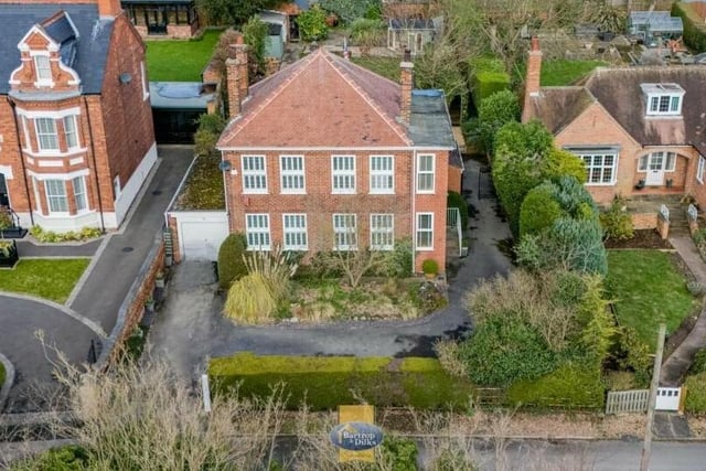 This aerial shot gives a revealing bird's eye view of the distinctive period home and its plot of land.
