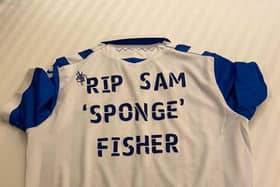 A Sheffield Wednesday shirt dedicated to Sam Fisher, the reverse of which has been signed by all the Owls players