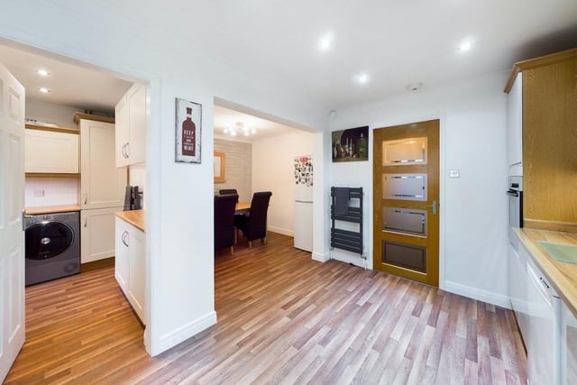 The kitchen has a handy layout, with the utility room and a dining area not far away.