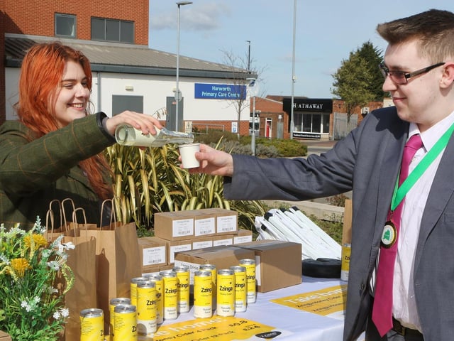 Bassetlaw Youth Mayor Malachi Carroll tries a honey infused drink from Zzinga Cider's Emma Bassindale.