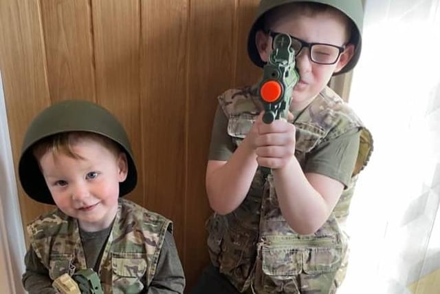 Despite being poorly, brothers Cody, aged eight, and Corey Colclough, aged two, dressed up as their heroes - the men at women who fight for our country - while at home.