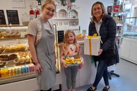 Jade welcomes Sofia and Phoebe to collect the Retford Easter Egg Hunt prize from Nicole Olivia's Cake Designs