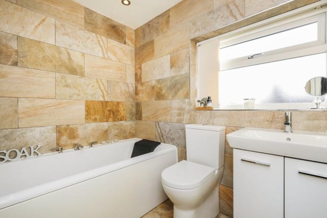 The family bathroom is smart and contemporary. It contains a bath, shower cubicle, hand wash basin with cupboards underneath and low-flush WC.