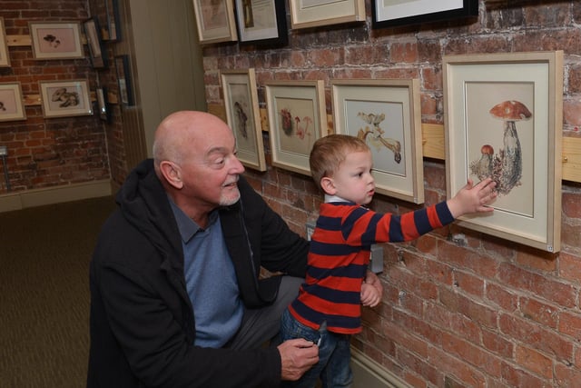 Keith Stubbs with Grandson Luke Jones, two looking at Beatrix Potter art in 2017