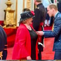 Jackie Scott receiving her MBE from Prince William