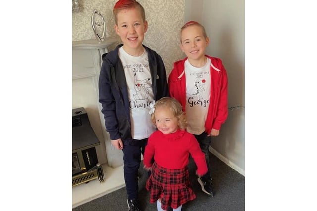 This sibling trio all dressed up with bright smiles and red in their outfits. Pictured: Charlie, aged eight, George, six, and little Elsie aged one.