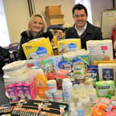 Ewa Romanczuk, Bassetlaw District Council leader Simon Greaves and Ewa Niec with the type of items needed for the refugees.