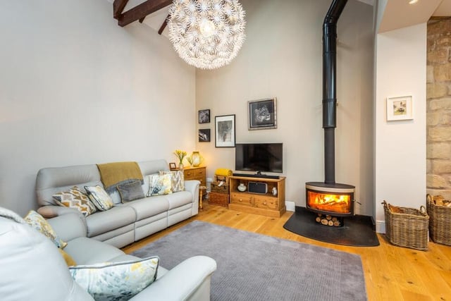 Another feature of the superb family room is a contemporary, free-standing log-burning stove.