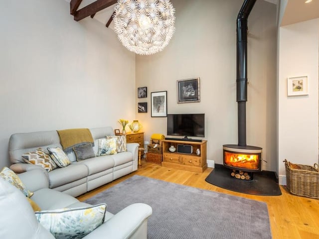 Another feature of the superb family room is a contemporary, free-standing log-burning stove.
