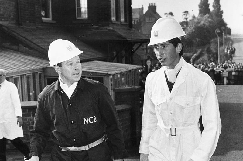 Prince Charles wearing a miners helmet and white overalls as he talks to General Manager W Barrett during a visit to Welbeck Colliery, near Worksop on July 19th 1968.