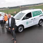 Councillor Darrel Pulk with council staff and two of the new electric vehicles