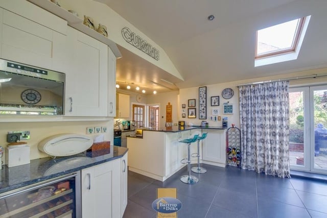 Integrated appliances within the kitchen include a range cooker, microwave, freezer and wine cooler.