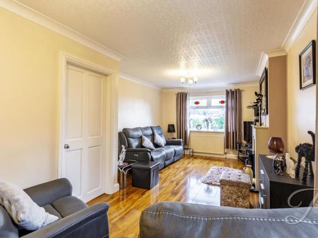 This second shot of the living room shows how lengthy and spacious it is, while the neutral-coloured walls would complement any style.The flooring is laminated, and there is a central heating radiator.
