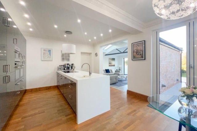Nice touches in the kitchen include uPVC double-glazed bi-fold doors leading out to the back garden, natural wood flooring with underfloor heating, a breakfast bar and decorative coving to the ceiling.