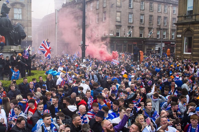 Flares were lit as Rangers fans gather at George Square this afternoon