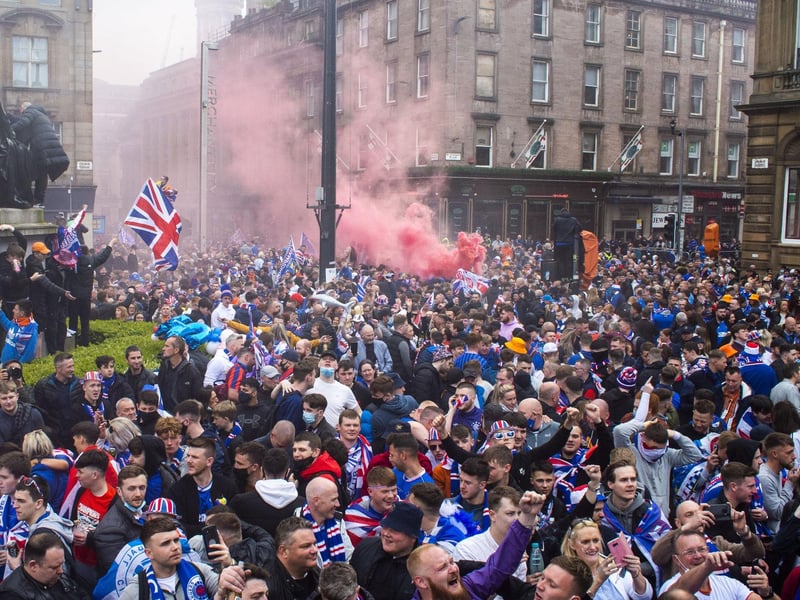 Flares were lit as Rangers fans gather at George Square this afternoon