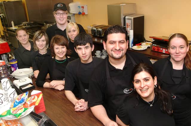 Leano Kaponas is pictured third from right with wife Diana (front) and Cafe Neo staff.