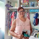 Mel Petersen holds a photo of her late grandmother, Pearl Key, in her new shop, named Pearly's Bargains.
