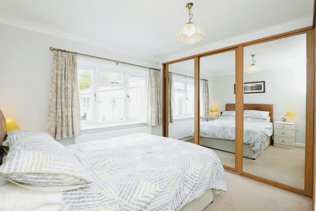 As you can see, this bedroom boasts extensive wardrobes, with mirrored doors.