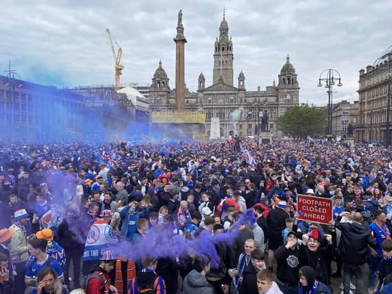 Rangers fans celebrate winning the Scottish Premiership title at George Square