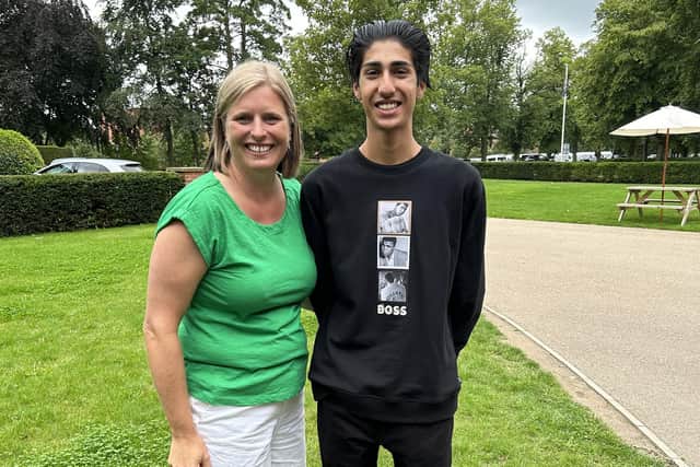 Elian celebrating his impressive results with science teacher Miss Dalby.