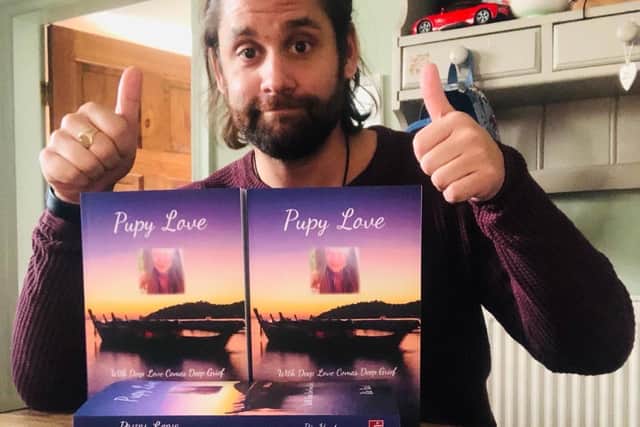 Ric Hart with copies of his new book, Pupy Love, which features a photo of late wife Jade on the cover.