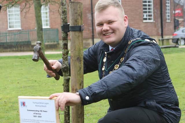 Bassetlaw Council Chairman Jack Bowker helped to fill the soil around the new cherry tree.