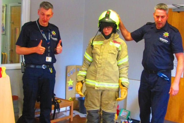 Nursery staff member Evie tried on the fire gear in a demonstration for the children.