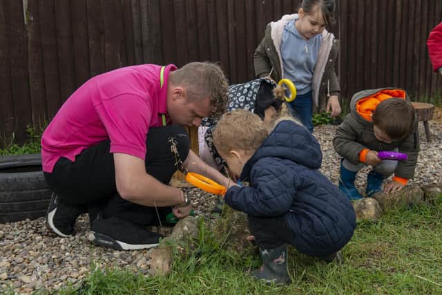 Lime Tree Nursery have created a new forest garden for the children, pictured with some of the children is After School Room Lead Charlie Wright