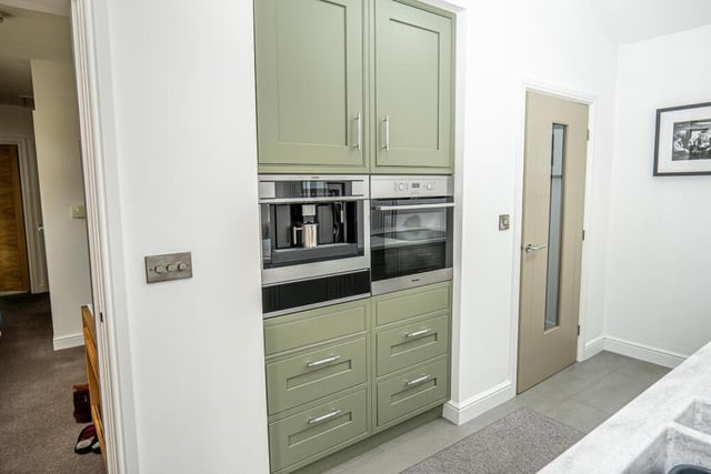 High-quality appliances in the attractive kitchen at the £469,000 property include this built-in coffee machine.