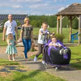 Jacob White and his family taking a walk in the hospice gardens