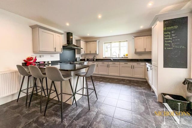 The first stop on our tour of the £475,000-plus Carlton in Lindrick house is the kitchen and breakfast room. It's a modern L-shaped space with peninsula breakfast bar, which forms a seating area, and a Rangemaster five-ring gas and electric cooker with double ovens, warming plates and matching extractor canopy over.