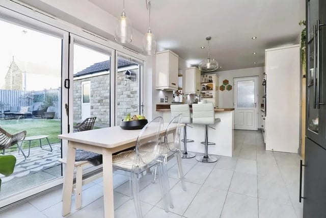 Let's start our tour of the £425,000 house in the stunning open-plan kitchen, which has a dining area with space for table and chairs. Large bi-folding doors give access to the rear garden.