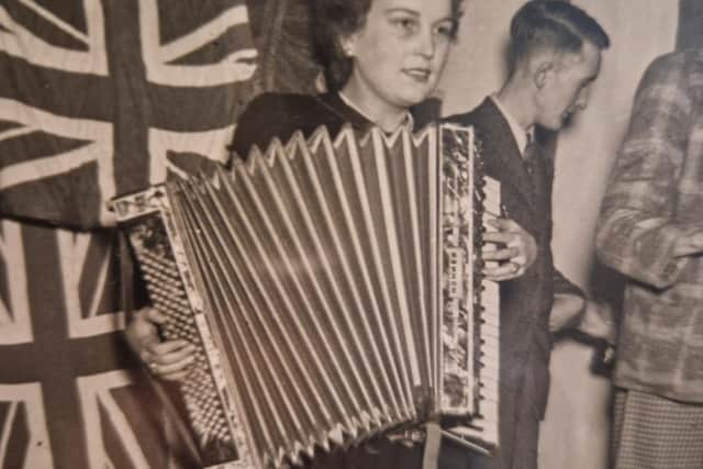 Esmeralda, the "talented accordion player" performing for crowds.