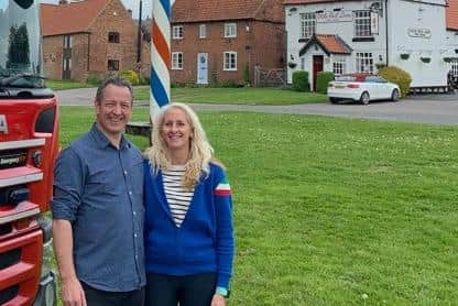 Phil Lawson and his partner, Pippa Slater, the co-chairs of the maypole day committee in Wellow, pictured in front of the maypole and the village green.