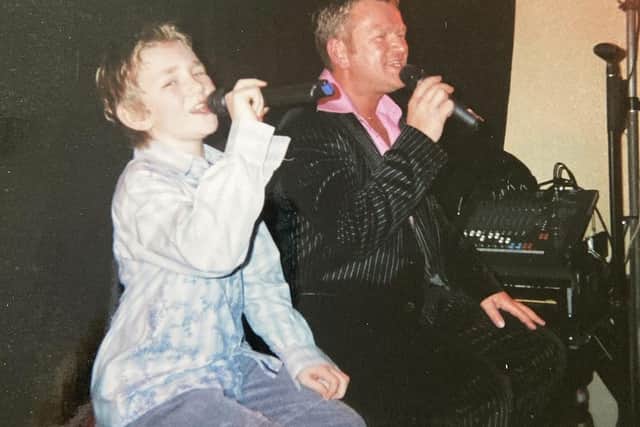 Harry sining as a youngster with his dad, Rob.