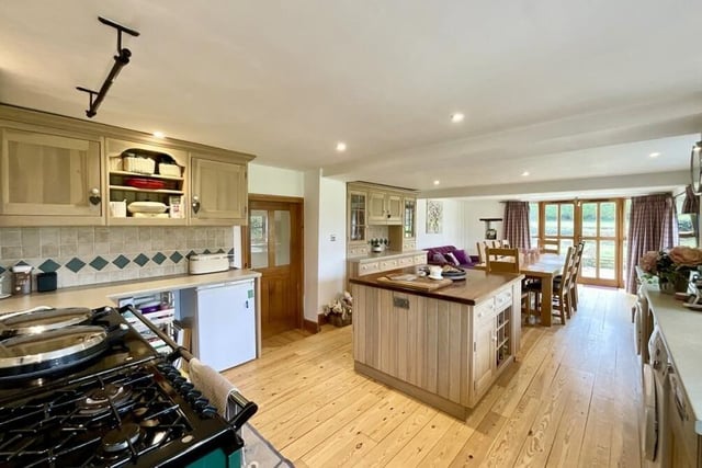 The central hub of the Gildingwells home is an open-plan kitchen/living/dining space. The kitchen exudes practicality and style, featuring an Aga, a substantial range of wall and base cabinets, work surfaces and a central island unit.