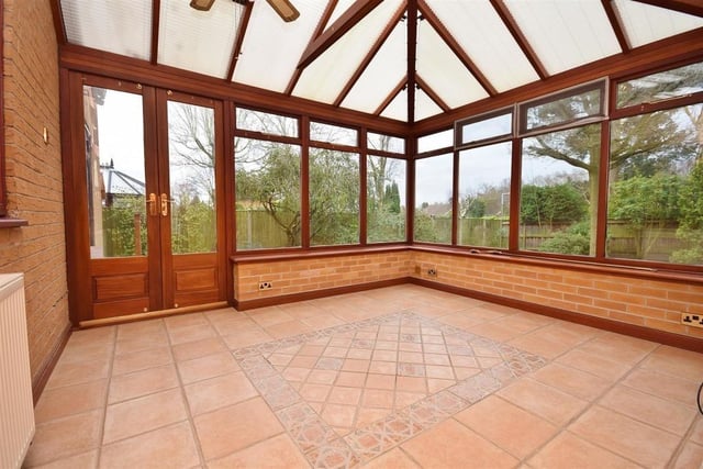The light-filled conservatory offers a panoramic view of the stunning back garden, with uPVC windows to the side and rear, plus uPVC doors leading straight on to the patio. The floor is tiled.