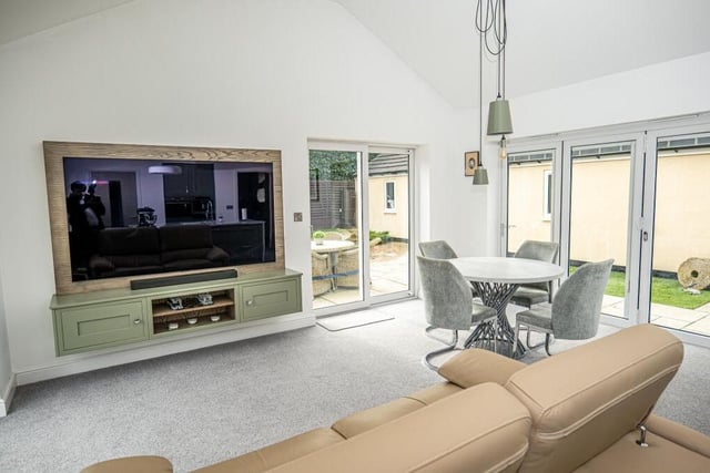 The dining space fits neatly within the open-plan area of the home. After your meal, you can go through the bi-folding doors into the garden or relax on the sofa in front of the big-screen TV.