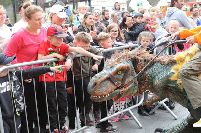 Crowds get close to one of the dinosaurs at the event in Worksop town centre.