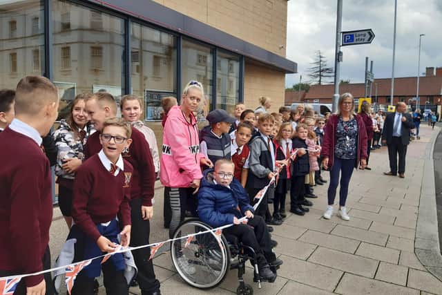 Children from Worksop Priory lined the outside of Savoy Cinema to cheer on the cyclists.