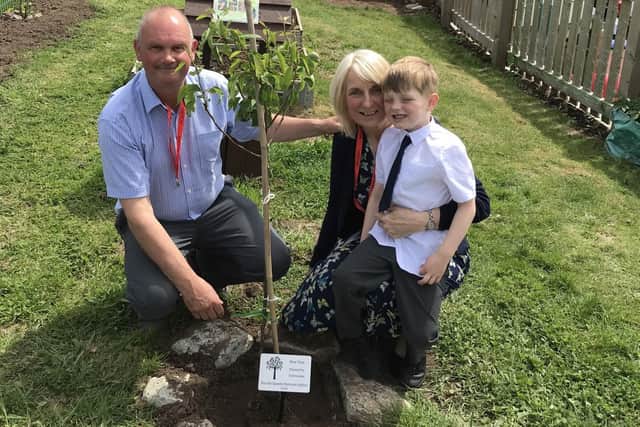 Ted was one of the students who planted a fruit tree for the Queen's Green Canopy, with the help of his grandparents.