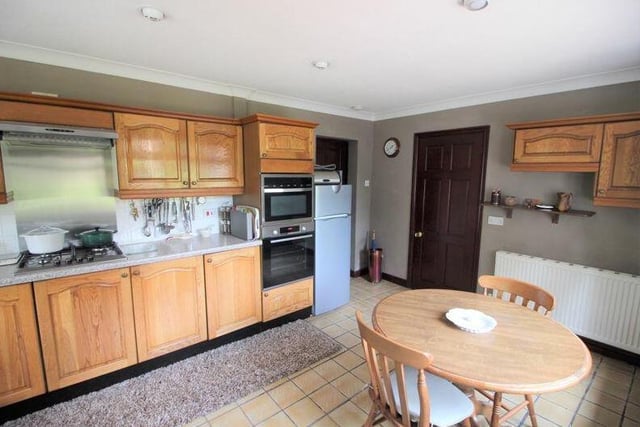 The kitchen is a welcoming space and comes with a range of appliances, including an integrated double electric oven and four-ring gas hob with extractor fan above. There is space for a free-standing fridge/freezer.